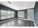 Comfortable living room with plank flooring, neutral wall paint, and bright windows at 3125 Beaver Creek Dr, Wesley Chapel, FL 33543