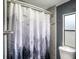 Well maintained bathroom features decorative shower curtain and window letting in natural light at 3125 Beaver Creek Dr, Wesley Chapel, FL 33543