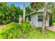 Backyard of home with lush tropical foliage surrounding the small building in the backyard at 3225 Rosery Ne Rd, Largo, FL 33771