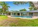 Backyard with a pool, lush landscaping, and a view of the water, ideal for relaxation at 3225 Rosery Ne Rd, Largo, FL 33771