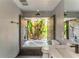 The bathroom showcases a modern design and a view of lush greenery at 3225 Rosery Ne Rd, Largo, FL 33771