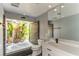 Unique bathroom features a soaking tub and a garden view at 3225 Rosery Ne Rd, Largo, FL 33771