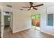 The bedroom features light wood floors and sliding door to patio at 3225 Rosery Ne Rd, Largo, FL 33771