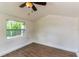 Bright bedroom with wood-look floors, a ceiling fan and a large window at 3225 Rosery Ne Rd, Largo, FL 33771