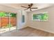 This bedroom features a ceiling fan and a sliding glass door at 3225 Rosery Ne Rd, Largo, FL 33771