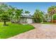 Exterior view featuring a brick driveway, lawn and a two-car garage at 3225 Rosery Ne Rd, Largo, FL 33771