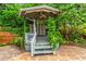 Charming gazebo with ornate details surrounded by lush greenery and a patterned tile patio at 3225 Rosery Ne Rd, Largo, FL 33771