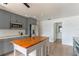 Spacious kitchen with grey cabinets, stainless steel appliances, and a butcher block island at 3225 Rosery Ne Rd, Largo, FL 33771