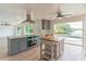 Well-lit kitchen with stainless steel appliances, a central island, and a view of the backyard pool at 3225 Rosery Ne Rd, Largo, FL 33771