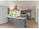 Modern kitchen with stainless steel appliances, gray cabinets, an island, and ample counter space at 3225 Rosery Ne Rd, Largo, FL 33771