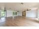 Open living space featuring hardwood floors, recessed lights, and large windows at 3225 Rosery Ne Rd, Largo, FL 33771