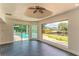 Bright living room boasts waterfront views, pool access, and modern ceiling fan at 3225 Rosery Ne Rd, Largo, FL 33771