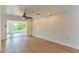 Bright living room with light hardwood flooring and large window offering backyard views at 3225 Rosery Ne Rd, Largo, FL 33771