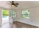 Bright living space with wood-look floors and a view of the pool at 3225 Rosery Ne Rd, Largo, FL 33771