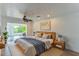 Bright main bedroom with hardwood flooring, large window, and modern decor at 3225 Rosery Ne Rd, Largo, FL 33771