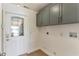 Mud room area with storage cabinets and a decorated glass window on the front door at 3225 Rosery Ne Rd, Largo, FL 33771