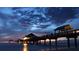 Scenic view of a pier at sunset with lights reflecting on the water at 3225 Rosery Ne Rd, Largo, FL 33771