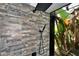 Modern shower featuring rainfall shower head, handheld sprayer, and serene outdoor views at 3225 Rosery Ne Rd, Largo, FL 33771