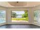 Bright sunroom with tile floors and large picture windows offers panoramic water views at 3225 Rosery Ne Rd, Largo, FL 33771