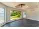 Spacious sunroom with tile floors and large windows providing ample natural light and view of lush backyard at 3225 Rosery Ne Rd, Largo, FL 33771
