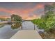 Waterfront property with private dock access and stunning views of the calm waterway at sunset at 3225 Rosery Ne Rd, Largo, FL 33771