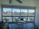 Enclosed patio with seating featuring views of the canal and nearby docks at 326 Windrush Blvd # 103, Indian Rocks Beach, FL 33785