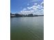Wide shot of waterfront area showing calm water, boat docks, and lush tropical foliage at 326 Windrush Blvd # 103, Indian Rocks Beach, FL 33785