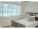 Bedroom features wood flooring, large window with blinds and an exterior view at 4016 Grayton Dr, New Port Richey, FL 34652