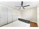 Cozy bedroom featuring a ceiling fan, closet with bi-fold doors, and wood-look floors at 4016 Grayton Dr, New Port Richey, FL 34652