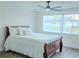 Bedroom features wood flooring, fan, and a large window with blinds at 4016 Grayton Dr, New Port Richey, FL 34652
