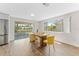 Dining room features a sliding glass door, wood table and yellow chairs at 4016 Grayton Dr, New Port Richey, FL 34652