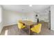 Dining room features a wood table and yellow chairs. The kitchen can be seen in the background at 4016 Grayton Dr, New Port Richey, FL 34652