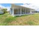 Rear exterior view of the home with an enclosed patio at 4016 Grayton Dr, New Port Richey, FL 34652