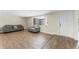 Bright living room featuring hard wood floors, modern furniture, and ample natural light at 4016 Grayton Dr, New Port Richey, FL 34652