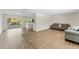 Open living area featuring hardwood floors, neutral paint, and sliding glass doors at 4016 Grayton Dr, New Port Richey, FL 34652