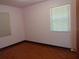 Bedroom with hardwood floors and a window, offering a simple and bright living space at 4105 W Tyson Ave, Tampa, FL 33611
