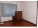 Bedroom featuring wood floors, dresser and natural light from the window at 4105 W Tyson Ave, Tampa, FL 33611