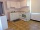 Functional kitchen features classic white cabinetry, appliances, and a window for natural light at 4105 W Tyson Ave, Tampa, FL 33611