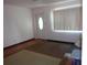 Cozy living room featuring a large window, a white front door, and neutral-toned carpet flooring at 4105 W Tyson Ave, Tampa, FL 33611