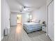 Large bedroom features wood-look floors, a ceiling fan, and an ensuite bathroom at 4207 S Dale Mabry Hwy # 2101, Tampa, FL 33611