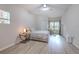 Bright bedroom with wood-look floors, ceiling fan, and large window with wood blinds at 4207 S Dale Mabry Hwy # 2101, Tampa, FL 33611