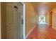 Condo hallway with yellow walls and red painted floor leading to bright outdoor area at 4207 S Dale Mabry Hwy # 2101, Tampa, FL 33611