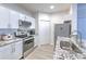 Bright kitchen with white cabinets, granite countertops, and stainless appliances at 4207 S Dale Mabry Hwy # 2101, Tampa, FL 33611