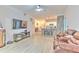 Bright living room with wood-look flooring, kitchen bar, and large television at 4207 S Dale Mabry Hwy # 2101, Tampa, FL 33611