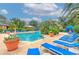 Stunning community pool with beautiful landscaping, lounge chairs and sunny skies at 4207 S Dale Mabry Hwy # 2101, Tampa, FL 33611