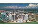 Stunning aerial view of condos with a waterfront pool, lush landscaping, and panoramic city and ocean views at 440 S Gulfview Blvd # 701, Clearwater Beach, FL 33767