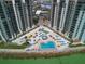 Aerial view of condo towers showing a unique community pool and stunning beachfront views at 440 S Gulfview Blvd # 701, Clearwater Beach, FL 33767