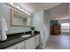 Vanity with granite countertops and new light fixtures in the main bathroom at 440 S Gulfview Blvd # 701, Clearwater Beach, FL 33767