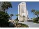Condo complex exterior with 440 West signage and mature tropical landscaping at 440 S Gulfview Blvd # 701, Clearwater Beach, FL 33767