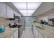 Well-equipped kitchen featuring granite countertops, modern stainless steel appliances, and tile backsplash at 440 S Gulfview Blvd # 701, Clearwater Beach, FL 33767